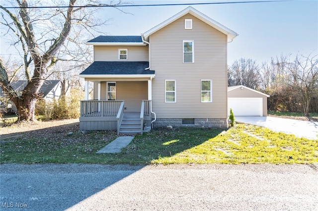 view of front property with an outbuilding, a front yard, a porch, and a garage