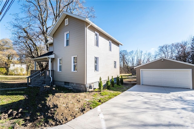 view of side of home featuring a garage and an outdoor structure