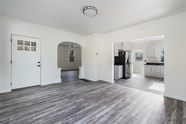 unfurnished living room featuring dark hardwood / wood-style floors