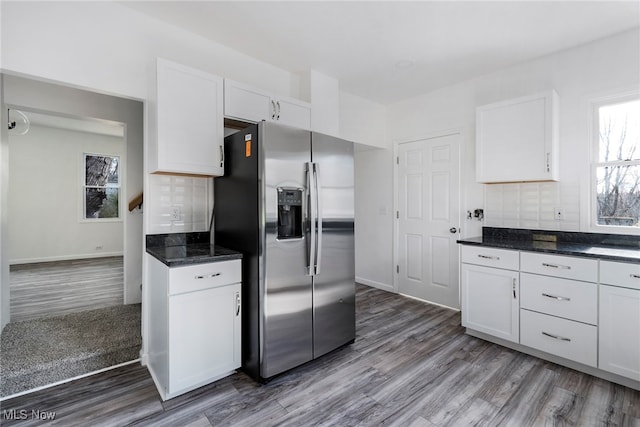 kitchen with white cabinetry, stainless steel refrigerator with ice dispenser, and hardwood / wood-style flooring