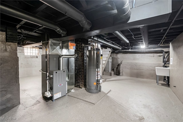 basement featuring gas water heater, heating unit, and sink