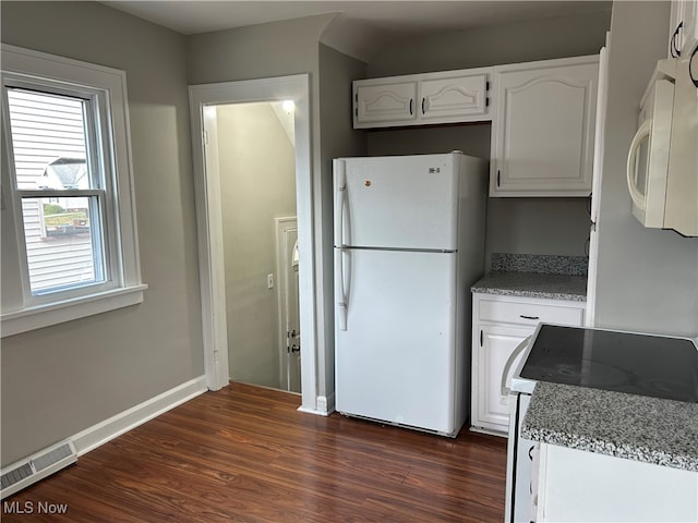 kitchen with white cabinets, white appliances, dark hardwood / wood-style floors, and light stone counters