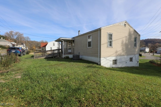 view of property exterior with a yard and a deck