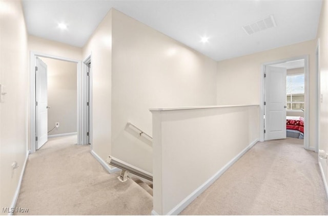 hallway with light colored carpet