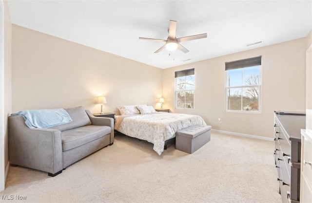 bedroom with ceiling fan and light carpet