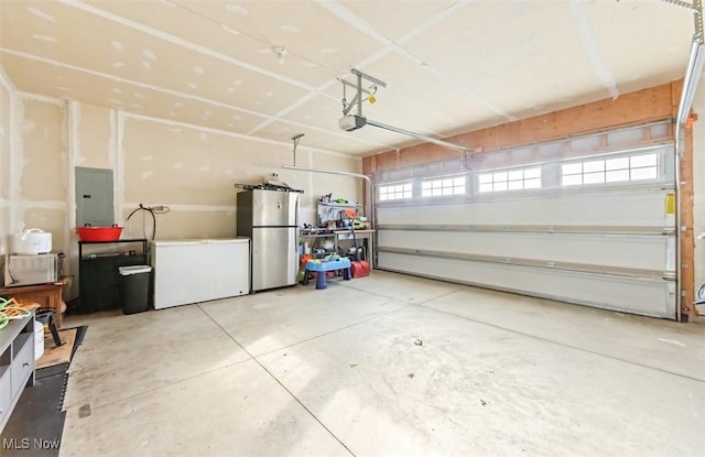 garage with stainless steel fridge, electric panel, and fridge