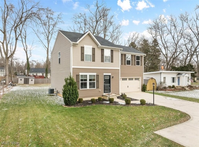 view of front facade featuring a garage, a front lawn, and central air condition unit