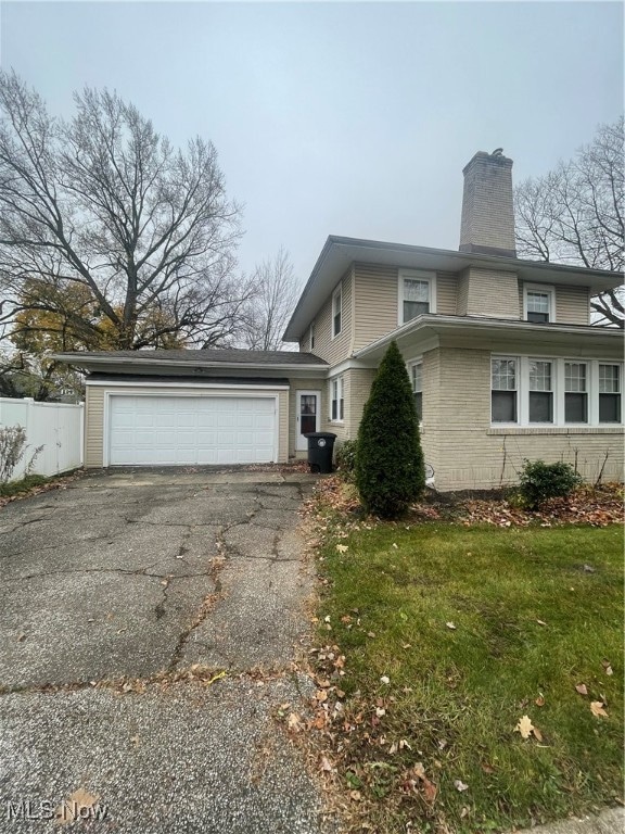 view of front of property with a front lawn and a garage