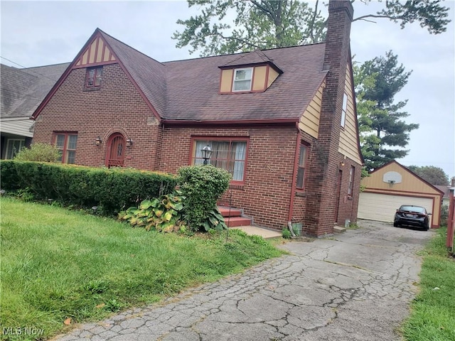 486 Madera, Youngstown, OH 44504 - tudor-style house with brick siding, a chimney, an outdoor structure, and a garage