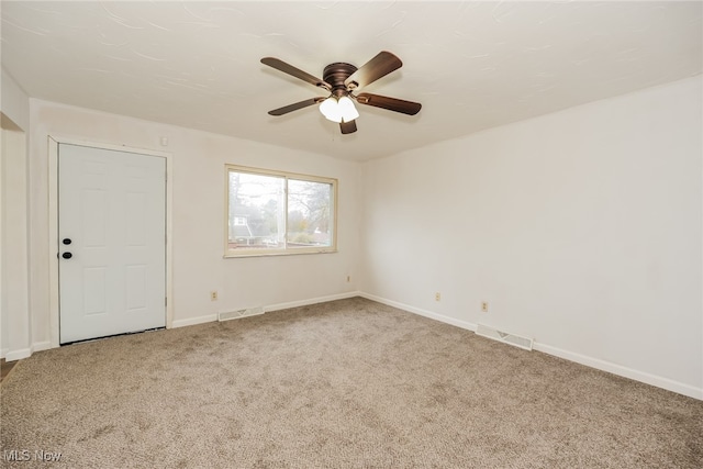 carpeted empty room featuring ceiling fan