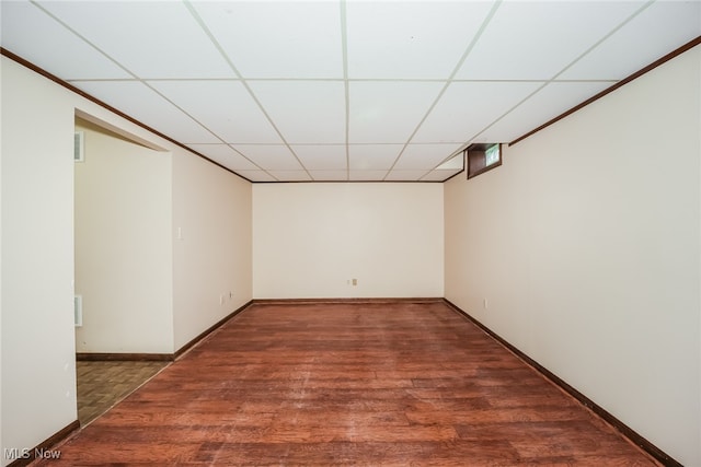 interior space featuring a drop ceiling and dark hardwood / wood-style floors