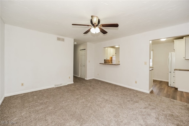 unfurnished living room with carpet flooring and ceiling fan