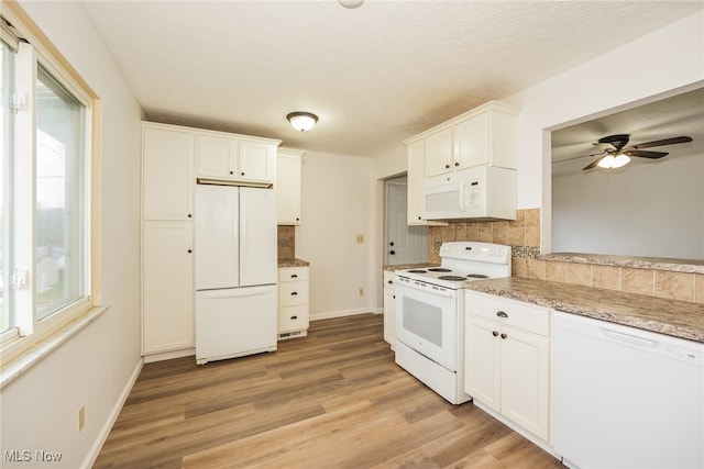 kitchen featuring white cabinetry, ceiling fan, light hardwood / wood-style flooring, white appliances, and decorative backsplash