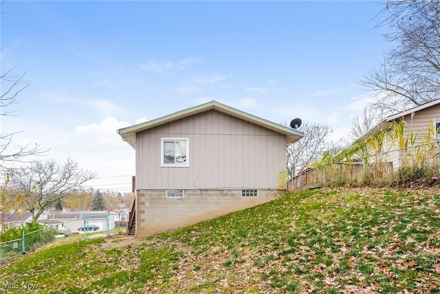 view of side of home with a yard