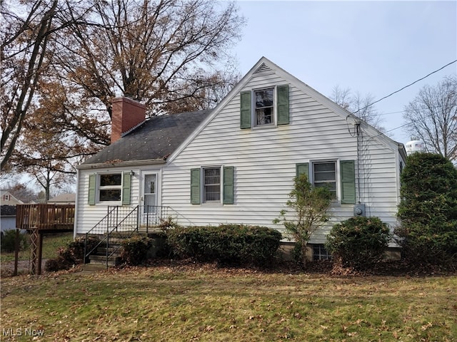 view of home's exterior featuring a lawn and a wooden deck