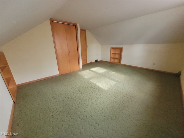 bonus room featuring lofted ceiling and carpet floors