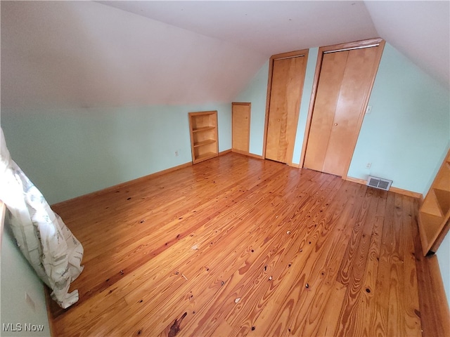 bonus room featuring light hardwood / wood-style floors and lofted ceiling