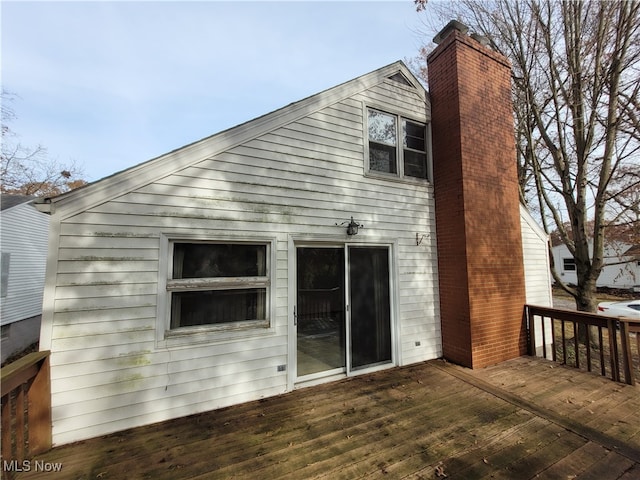 back of property featuring a deck