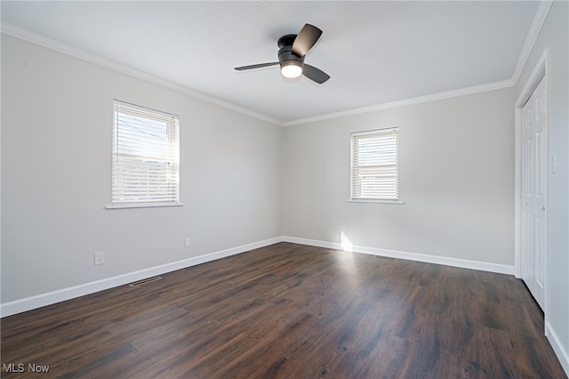 empty room with ceiling fan, dark hardwood / wood-style flooring, ornamental molding, and a wealth of natural light