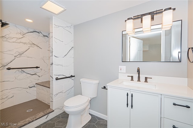 bathroom with a shower, vanity, and toilet