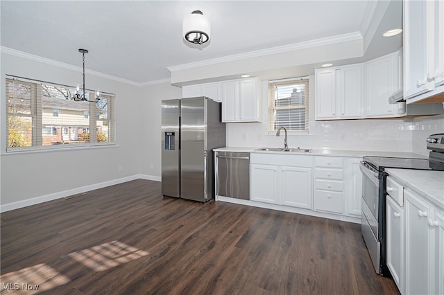 kitchen featuring white cabinets, appliances with stainless steel finishes, dark hardwood / wood-style flooring, and ornamental molding