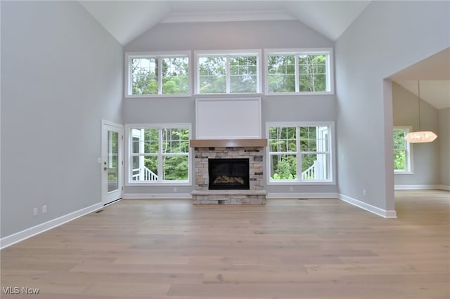 unfurnished living room with a healthy amount of sunlight, a fireplace, and light hardwood / wood-style flooring