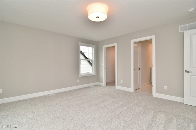 unfurnished bedroom with light colored carpet