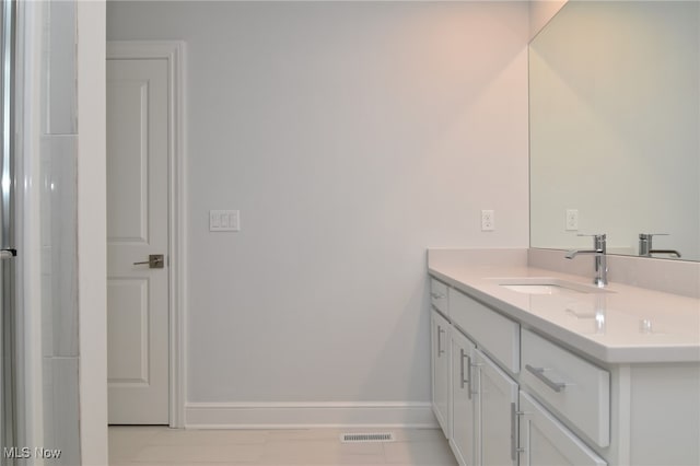 bathroom with tile patterned flooring and vanity