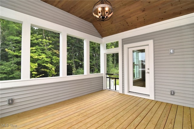 unfurnished sunroom with vaulted ceiling and wooden ceiling