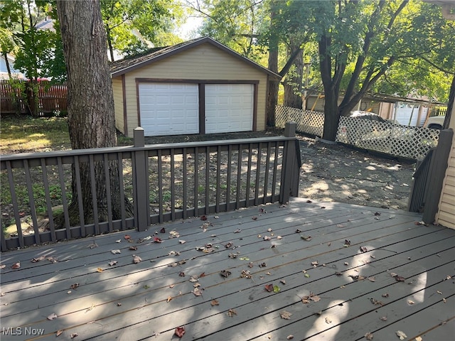 deck with a garage and an outdoor structure