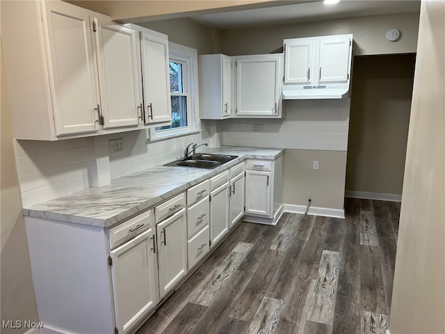 kitchen with dark hardwood / wood-style flooring, white cabinetry, and sink