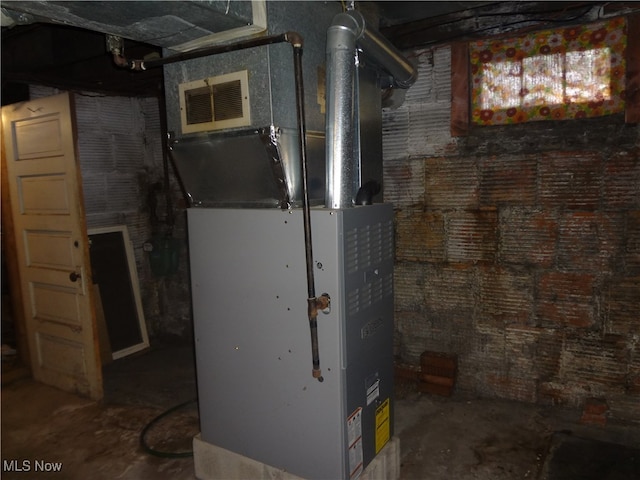 utility room with heating unit