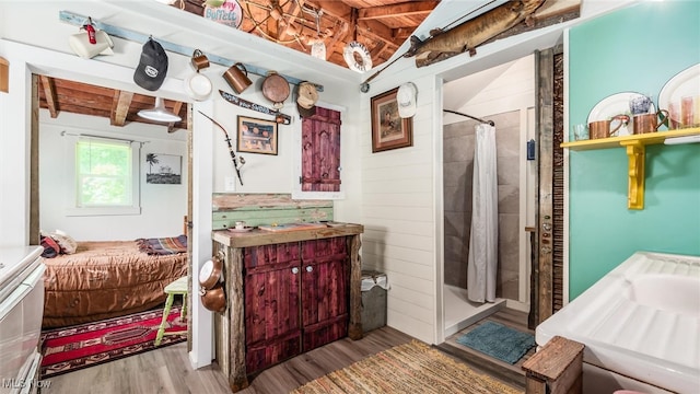 bathroom featuring walk in shower, beamed ceiling, wood ceiling, and hardwood / wood-style flooring