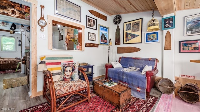 sitting room featuring wood ceiling, vaulted ceiling, and hardwood / wood-style flooring