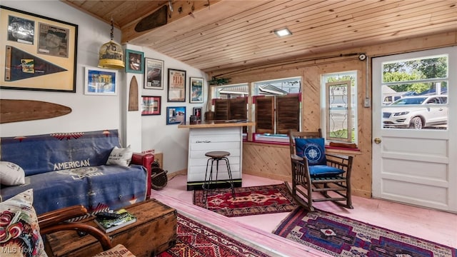 living area featuring vaulted ceiling with beams, wooden walls, and wooden ceiling