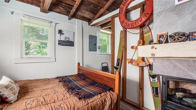 bedroom with a fireplace, vaulted ceiling with beams, electric panel, and wooden ceiling