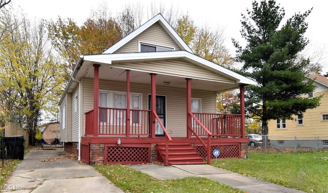 view of front facade with a front yard and a porch