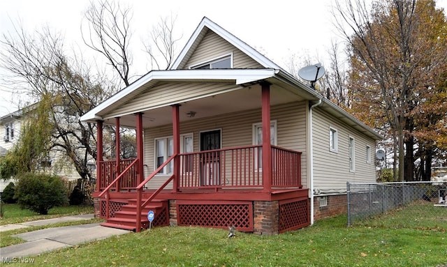 view of front of house featuring covered porch and a front lawn