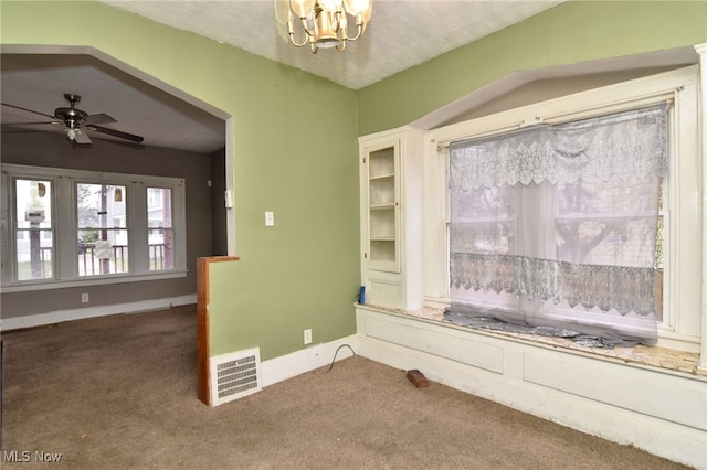 spare room with carpet, a textured ceiling, and ceiling fan with notable chandelier