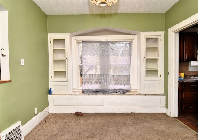 room details featuring carpet floors and a textured ceiling