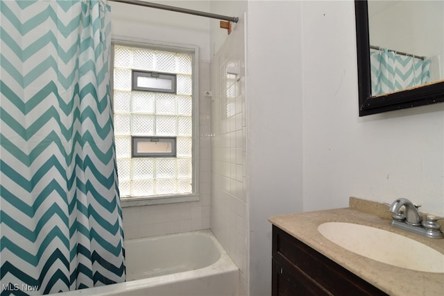 bathroom with vanity, shower / tub combo with curtain, and plenty of natural light