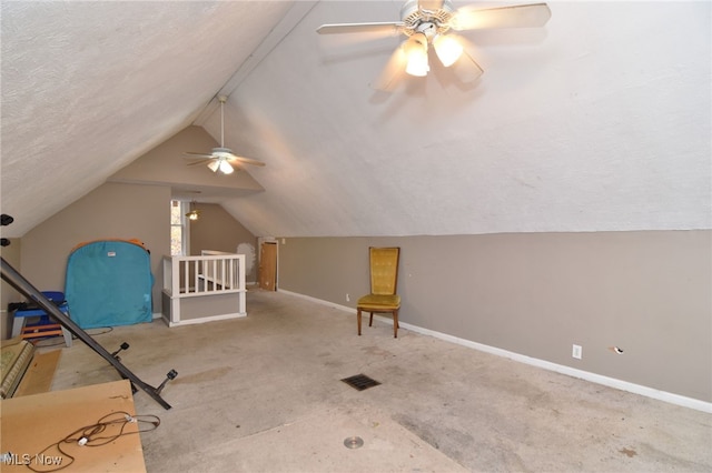 bonus room featuring a textured ceiling, ceiling fan, light colored carpet, and lofted ceiling