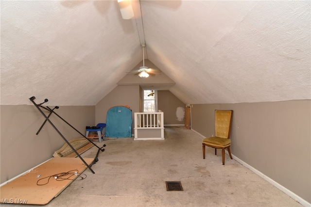 bonus room featuring ceiling fan, light colored carpet, a textured ceiling, and vaulted ceiling