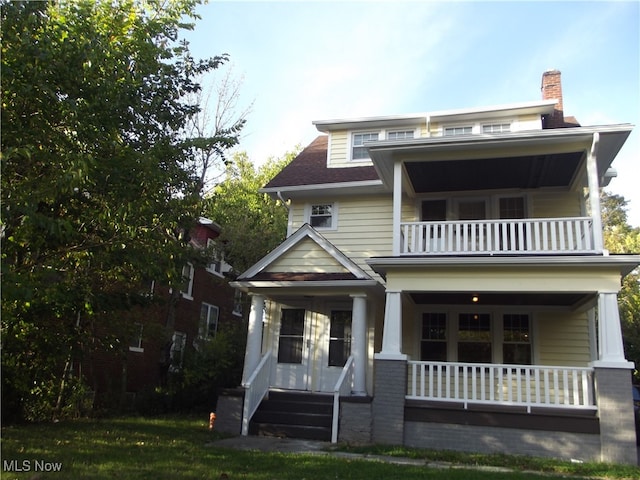 view of front of house featuring covered porch and a balcony