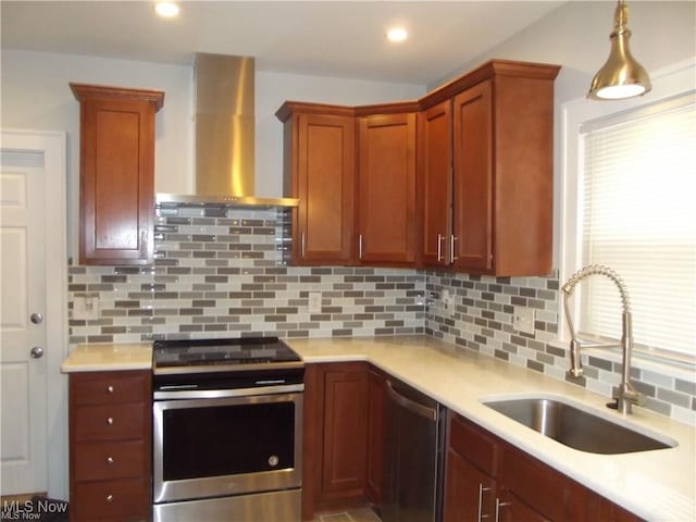 kitchen featuring wall chimney range hood, sink, appliances with stainless steel finishes, and tasteful backsplash