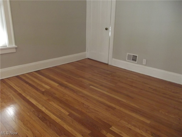 spare room featuring wood-type flooring