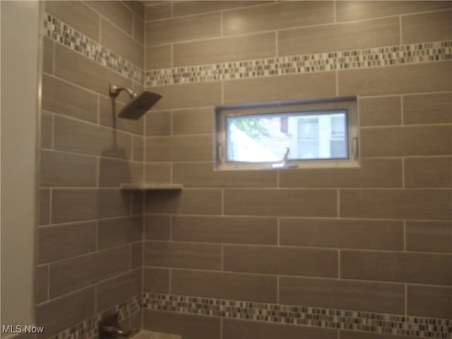 bathroom with tiled shower