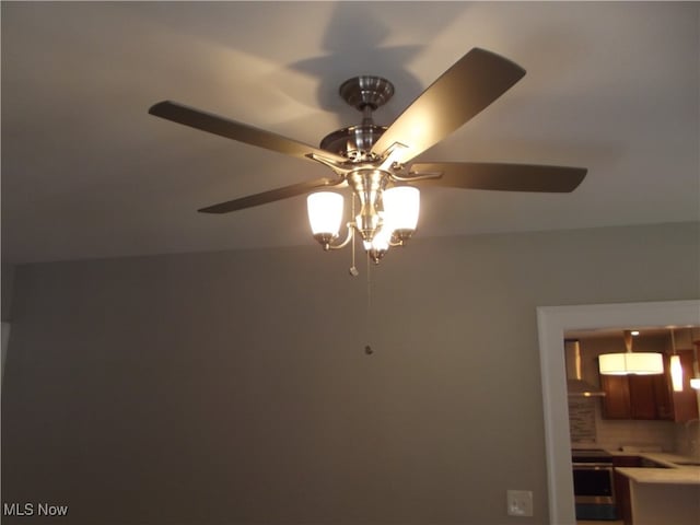 room details featuring electric range, ceiling fan, wall chimney range hood, and tasteful backsplash