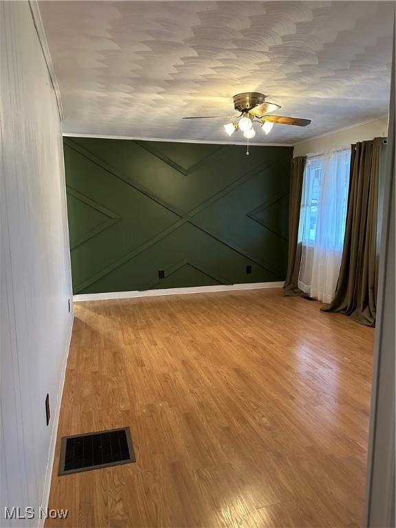 unfurnished room featuring hardwood / wood-style flooring and ceiling fan