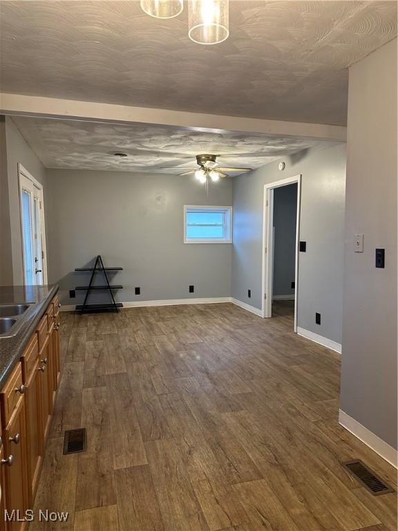 washroom featuring ceiling fan and dark wood-type flooring